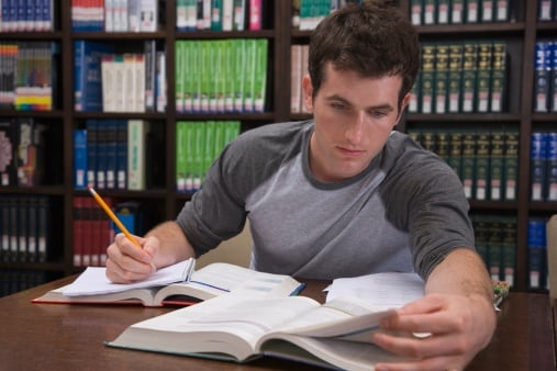Guy studying in library